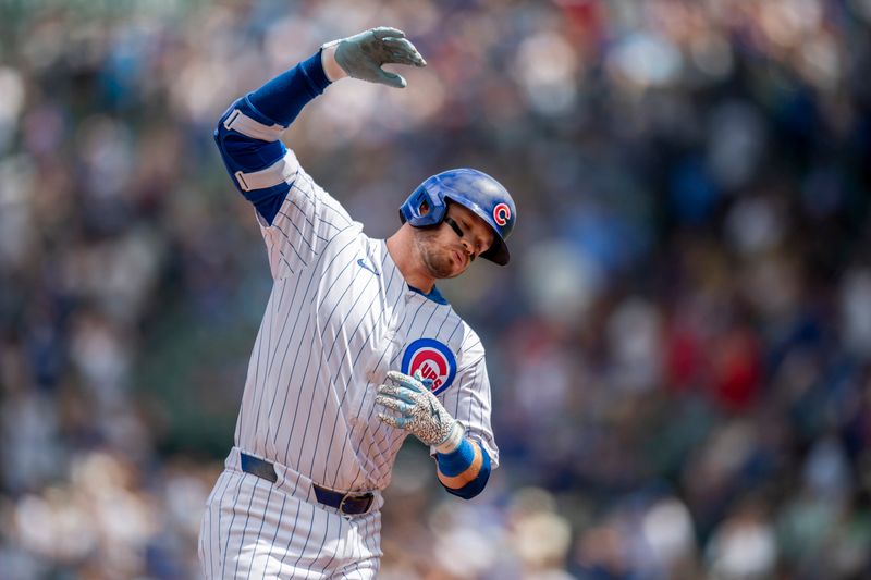 Aug 17, 2024; Chicago, Illinois, USA; Chicago Cubs left fielder Ian Happ (8) celebrates while rounding the bases after hitting a home run during the first inning against the Toronto Blue Jays at Wrigley Field. Mandatory Credit: Patrick Gorski-USA TODAY Sports