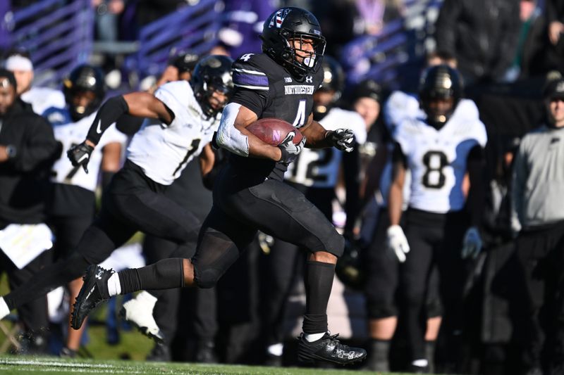 Nov 18, 2023; Evanston, Illinois, USA;  Northwestern Wildcats running back Cam Porter (4) runs for a touchdown in the fourth quarter against the Purdue Boilermakers at Ryan Field. Mandatory Credit: Jamie Sabau-USA TODAY Sports