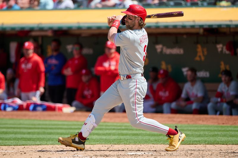 Jun 17, 2023; Oakland, California, USA; Philadelphia Phillies designated hitter Bryce Harper (3) hits a single against the Oakland Athletics during the eighth inning at Oakland-Alameda County Coliseum. Mandatory Credit: Robert Edwards-USA TODAY Sports