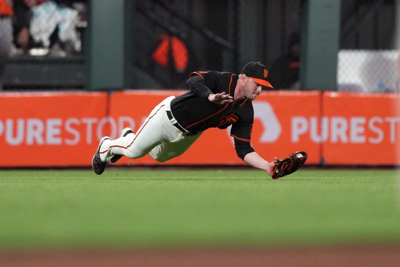 Jun 3, 2023; San Francisco, California, USA;  San Francisco Giants center fielder Austin Slater (13) catches a fly ball against the Baltimore Orioles during the seventh inning at Oracle Park. Mandatory Credit: Darren Yamashita-USA TODAY Sports