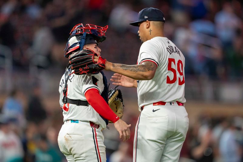 May 8, 2024; Minneapolis, Minnesota, USA; Minnesota Twins pitcher Jhoan Duran (59) celebrates with catcher Christian Vázquez (8) after defeating the Seattle Mariners at Target Field. Mandatory Credit: Jesse Johnson-USA TODAY Sports