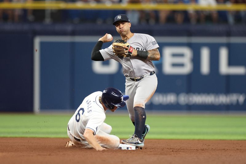 Jul 10, 2024; St. Petersburg, Florida, USA; New York Yankees second baseman Gleyber Torres (25) attempts a double play against the Tampa Bay Rays in the fifth inning  at Tropicana Field. Mandatory Credit: Nathan Ray Seebeck-USA TODAY Sports