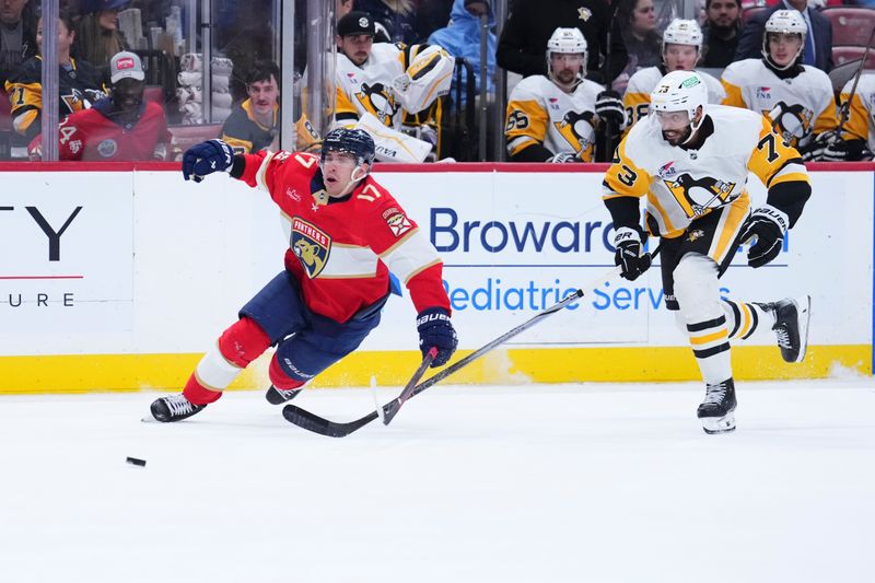 Jan 3, 2025; Sunrise, Florida, USA; Florida Panthers center Evan Rodrigues (17) and Pittsburgh Penguins defenseman P.O Joseph (73) battle for the puck during the third period at Amerant Bank Arena. Mandatory Credit: Rich Storry-Imagn Images