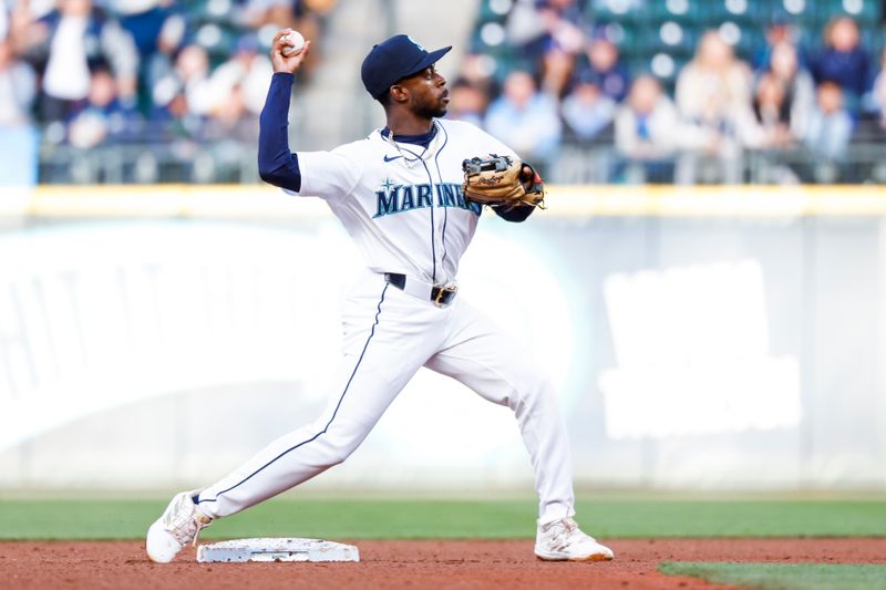 May 28, 2024; Seattle, Washington, USA; Seattle Mariners second baseman Ryan Bliss (1) attempts to turn a double play against the Houston Astros during the fourth inning at T-Mobile Park. Mandatory Credit: Joe Nicholson-USA TODAY Sports