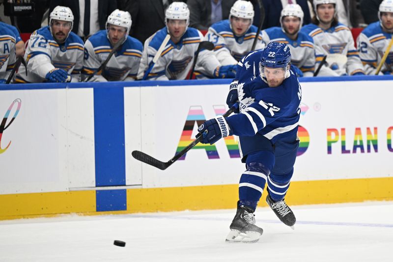 Nov 18, 2025; Toronto, Ontario, CAN;  Toronto Maple Leafs defenseman Jake McCabe (22) shoots the puck against the St. Louis Blues in the first period at Scotiabank Arena. Mandatory Credit: Dan Hamilton-Imagn Images