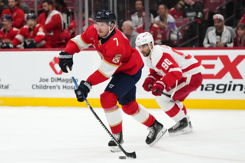 Jan 17, 2024; Sunrise, Florida, USA; Florida Panthers defenseman Dmitry Kulikov (7) passes the puck against the Detroit Red Wings during the first period at Amerant Bank Arena. Mandatory Credit: Jasen Vinlove-USA TODAY Sports