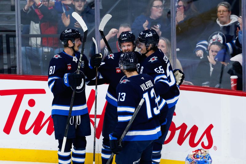Nov 18, 2025; Winnipeg, Manitoba, CAN;  Winnipeg Jets defenseman Josh Morrissey (44) is congratulated by his team mates on his goal against the Columbus Blue Jackets during the second period at Canada Life Centre. Mandatory Credit: Terrence Lee-Imagn Images