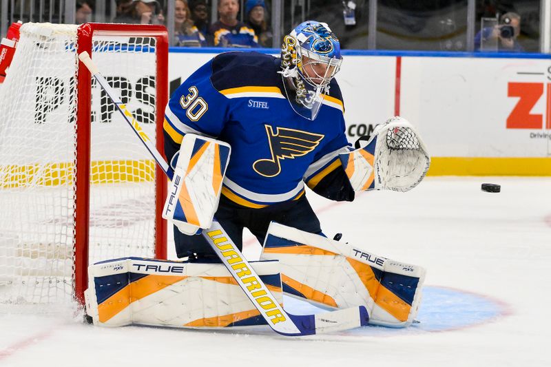 Oct 1, 2024; St. Louis, Missouri, USA;  St. Louis Blues goaltender Joel Hofer (30) defends the net against the Columbus Blue Jackets during the first period at Enterprise Center. Mandatory Credit: Jeff Curry-Imagn Images