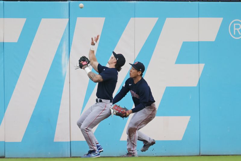 Jun 7, 2023; Cleveland, Ohio, USA; Boston Red Sox center fielder Jarren Duran, left, and left fielder Masataka Yoshida, right, field a ball hit by Cleveland Guardians first baseman Josh Naylor (not pictured) during the second inning at Progressive Field. Mandatory Credit: Ken Blaze-USA TODAY Sports