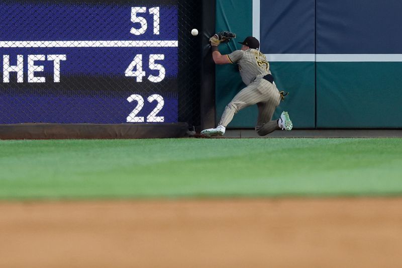 Jul 23, 2024; Washington, District of Columbia, USA; San Diego Padres outfielder Bryce Johnson (27) attempts a leaping catch a fly ball by Washington Nationals outfielder Lane Thomas (not pictured) during the sixth inning at Nationals Park. Mandatory Credit: Geoff Burke-USA TODAY Sports