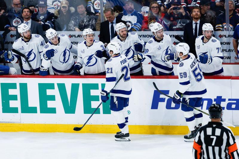 Mar 5, 2026; Winnipeg, Manitoba, CAN;  Tampa Bay Lightning forward Brayden Point (21) is congratulated by his team mates on his goal against the Winnipeg Jets during the third period at Canada Life Centre. Mandatory Credit: Terrence Lee-Imagn Images