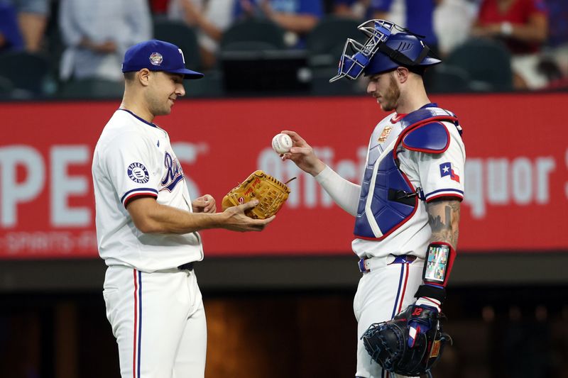 Jun 22, 2024; Arlington, Texas, USA;Texas Rangers catcher Jonah Heim (28) hands the ball to pitcher Brock Burke (46) after the game against the Kansas City Royals  at Globe Life Field. Mandatory Credit: Tim Heitman-USA TODAY Sports