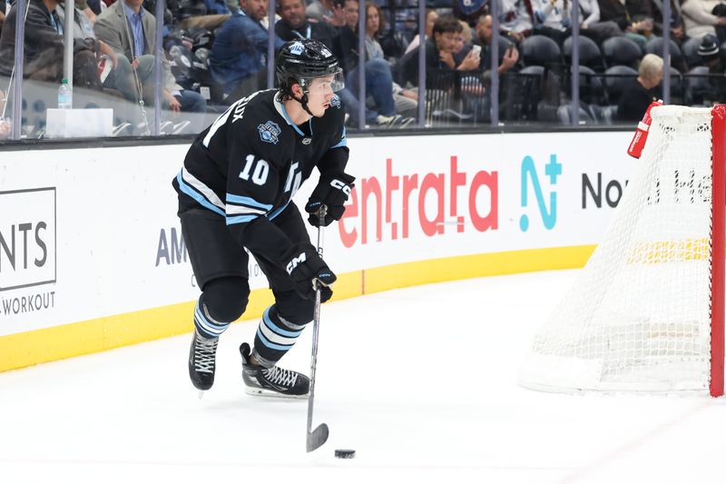 Oct 24, 2024; Salt Lake City, Utah, USA; Utah Hockey Club defenseman Maveric Lamoureux (10) looks to pass the puck against the Colorado Avalanche during the third period at Delta Center. Mandatory Credit: Rob Gray-Imagn Images