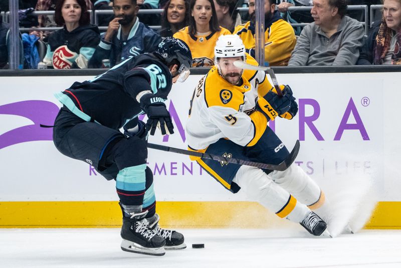 Nov 20, 2024; Seattle, Washington, USA;  Nashville Predators forward Filip Forsberg (9) skates against Seattle Kraken defenseman Brandon Montour (62) during the first period at Climate Pledge Arena. Mandatory Credit: Stephen Brashear-Imagn Images