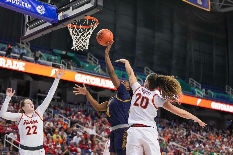 Mar 9, 2024; Greensboro, NC, USA; Notre Dame Fighting Irish guard KK Bransford (14) shoots the ball over Virginia Tech Hokies guard Olivia Summiel (20) during the second half at Greensboro Coliseum. Mandatory Credit: David Yeazell-USA TODAY Sports