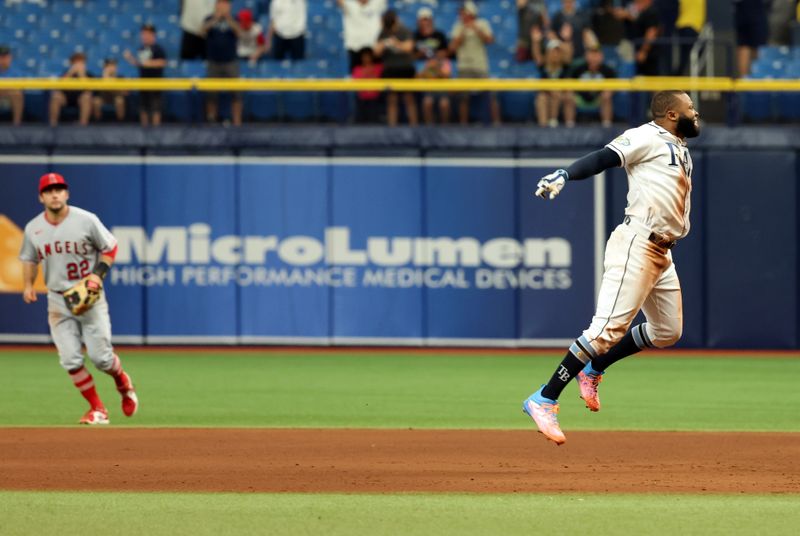 Sep 21, 2023; St. Petersburg, Florida, USA; Tampa Bay Rays center fielder Manuel Margot (13) celebrates after he hit the game winning walk off RBI during the ninth inning against the Los Angeles Angels at Tropicana Field. Mandatory Credit: Kim Klement Neitzel-USA TODAY Sports