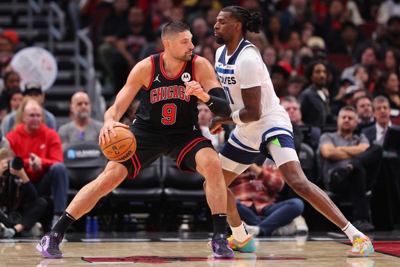 CHICAGO, ILLINOIS - NOVEMBER 07: Nikola Vucevic #9 of the Chicago Bulls is defended by Naz Reid #11 of the Minnesota Timberwolves during the second half at the United Center on November 07, 2024 in Chicago, Illinois. NOTE TO USER: User expressly acknowledges and agrees that, by downloading and or using this photograph, User is consenting to the terms and conditions of the Getty Images License Agreement.  (Photo by Michael Reaves/Getty Images)