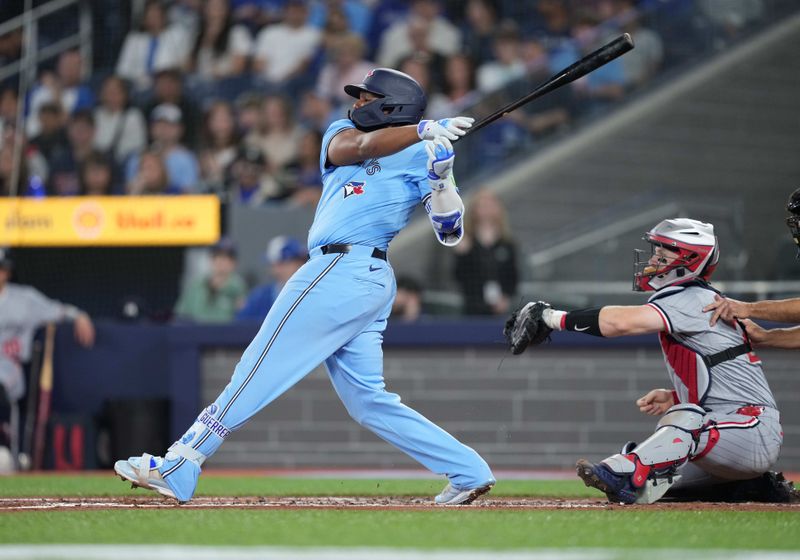 May 11, 2024; Toronto, Ontario, CAN; Toronto Blue Jays first base Vladimir Guerrero Jr. (27) hits a single against the Minnesota Twins during the first inning at Rogers Centre. Mandatory Credit: Nick Turchiaro-USA TODAY Sports