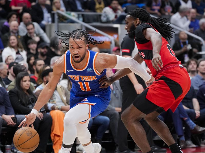 TORONTO, ON - MARCH 27: Jalen Brunson #11 of the New York Knicks dribbles against Javon Freeman-Liberty #0 of the Toronto Raptors during the first half of their basketball game at the Scotiabank Arena on March 27, 2024 in Toronto, Ontario, Canada. NOTE TO USER: User expressly acknowledges and agrees that, by downloading and/or using this Photograph, user is consenting to the terms and conditions of the Getty Images License Agreement. (Photo by Mark Blinch/Getty Images)