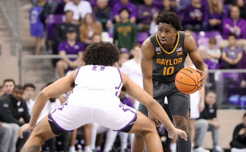 Feb 11, 2023; Fort Worth, Texas, USA;  Baylor Bears guard Adam Flagler (10) dribbles as TCU Horned Frogs guard Micah Peavy (0) defends during the second half at Ed and Rae Schollmaier Arena. Mandatory Credit: Kevin Jairaj-USA TODAY Sports