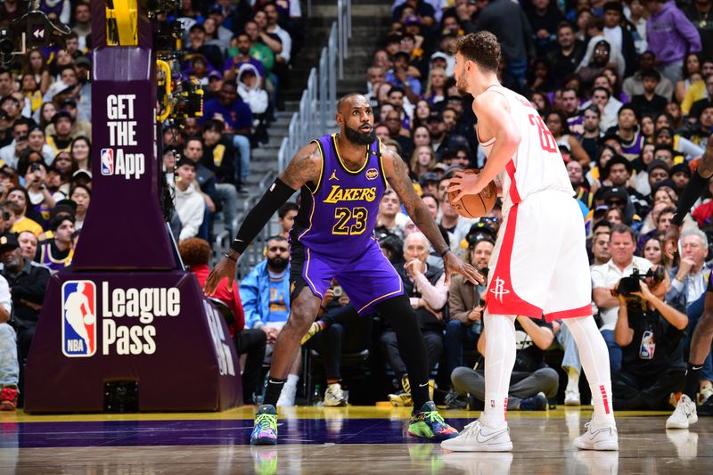 LOS ANGELES, CA - MARCH 31: Alperen Sengun #28 of the Houston Rockets handles the ball while LeBron James #23 of the Los Angeles Lakers plays defense during the game on March 31, 2025 at Crypto.Com Arena in Los Angeles, California. NOTE TO USER: User expressly acknowledges and agrees that, by downloading and/or using this Photograph, user is consenting to the terms and conditions of the Getty Images License Agreement. Mandatory Copyright Notice: Copyright 2025 NBAE (Photo by Adam Pantozzi/NBAE via Getty Images)