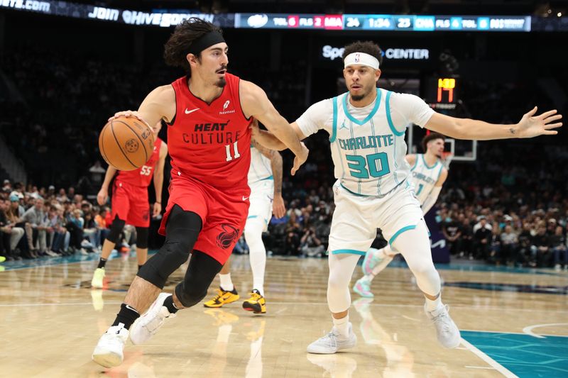 CHARLOTTE, NC - NOVEMBER 27:  Jaime Jaquez Jr. #11 of the Miami Heat dribbles the ball during the game against the Charlotte Hornets on November 27, 2024 at Spectrum Center in Charlotte, North Carolina. NOTE TO USER: User expressly acknowledges and agrees that, by downloading and or using this photograph, User is consenting to the terms and conditions of the Getty Images License Agreement. Mandatory Copyright Notice: Copyright 2024 NBAE (Photo by Brock Williams-Smith/NBAE via Getty Images)