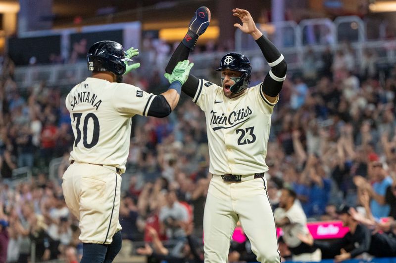 Sep 26, 2024; Minneapolis, Minnesota, USA; Minnesota Twins first base Carlos Santana (30) and third base Royce Lewis (23) score in the eighth inning to tie the game against the Miami Marlins at Target Field. Mandatory Credit: Matt Blewett-Imagn Images