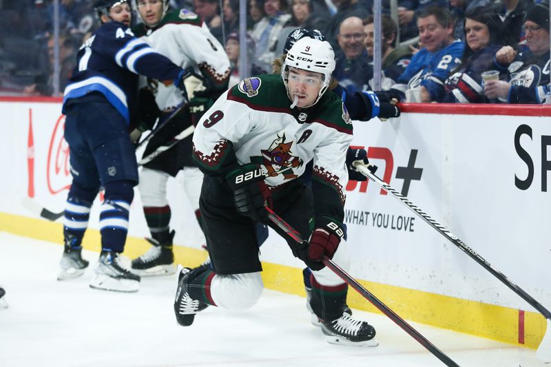 Jan 15, 2023; Winnipeg, Manitoba, CAN;  Arizona Coyotes forward Clayton Keller (9) looks to make a pass against the Winnipeg Jets during the first period at Canada Life Centre. Mandatory Credit: Terrence Lee-USA TODAY Sports