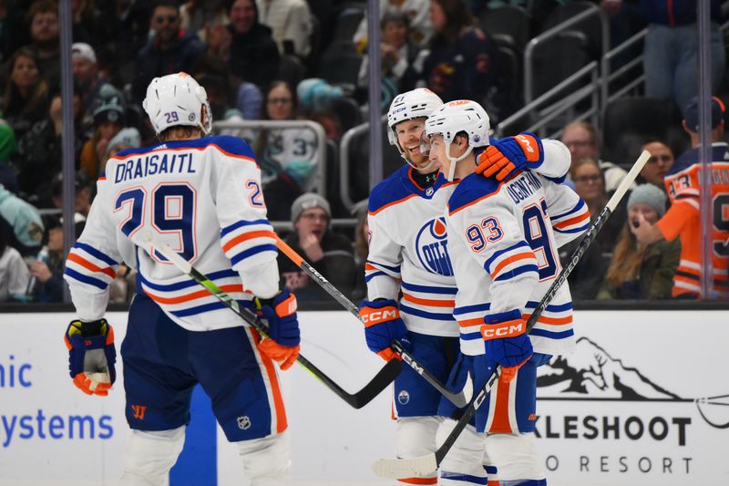 Mar 2, 2024; Seattle, Washington, USA; The Edmonton Oilers celebrate after a goal scored by defenseman Brett Kulak (27) during the third period against the Seattle Kraken at Climate Pledge Arena. Mandatory Credit: Steven Bisig-USA TODAY Sports