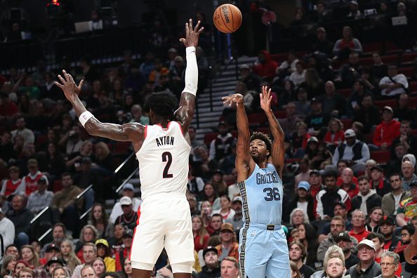 PORTLAND, OREGON - NOVEMBER 05: Marcus Smart #36 of the Memphis Grizzlies shoots over Deandre Ayton #2 of the Portland Trail Blazers during the first quarter at Moda Center on November 05, 2023 in Portland, Oregon. NOTE TO USER: User expressly acknowledges and agrees that, by downloading and or using this photograph, User is consenting to the terms and conditions of the Getty Images License Agreement.? (Photo by Amanda Loman/Getty Images)