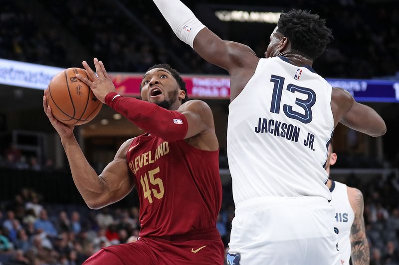 MEMPHIS, TENNESSEE - FEBRUARY 01: Donovan Mitchell #45 of the Cleveland Cavaliers goes to the basket against Jaren Jackson Jr. #13 of the Memphis Grizzlies during the first half at FedExForum on February 01, 2024 in Memphis, Tennessee. (Photo by Justin Ford/Getty Images)