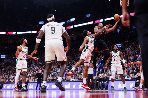 TORONTO, CANADA - NOVEMBER 15: Scottie Barnes #4 of the Toronto Raptors drives to the net against MarJon Beauchamp #3 of the Milwaukee Bucks during the first half of their NBA game at Scotiabank Arena on November 15, 2023 in Toronto, Canada. NOTE TO USER: User expressly acknowledges and agrees that, by downloading and or using this photograph, User is consenting to the terms and conditions of the Getty Images License Agreement. (Photo by Cole Burston/Getty Images)