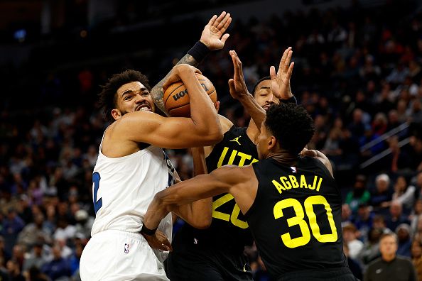 MINNEAPOLIS, MINNESOTA - NOVEMBER 30: Karl-Anthony Towns #32 of the Minnesota Timberwolves drives to the basket while John Collins #20 and Ochai Agbaji #30 of the Utah Jazz defend in the fourth quarter at Target Center on November 30, 2023 in Minneapolis, Minnesota. The Timberwolves defeated the Jazz 101-90. NOTE TO USER: User expressly acknowledges and agrees that, by downloading and or using this photograph, User is consenting to the terms and conditions of the Getty Images License Agreement. (Photo by David Berding/Getty Images)