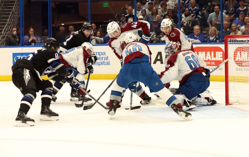 Feb 15, 2024; Tampa, Florida, USA; Tampa Bay Lightning right wing Nikita Kucherov (86) and center Brayden Point (21) shoot as Colorado Avalanche defends during the first period at Amalie Arena. Mandatory Credit: Kim Klement Neitzel-USA TODAY Sports