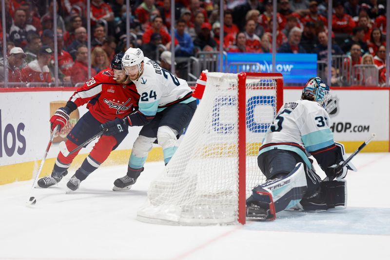 Jan 11, 2024; Washington, District of Columbia, USA; Washington Capitals right wing Anthony Mantha (39) skates with the puck behind Seattle Kraken goaltender Joey Daccord (35) as Kraken defenseman Jamie Oleksiak (24) defends in the third period at Capital One Arena. Mandatory Credit: Geoff Burke-USA TODAY Sports