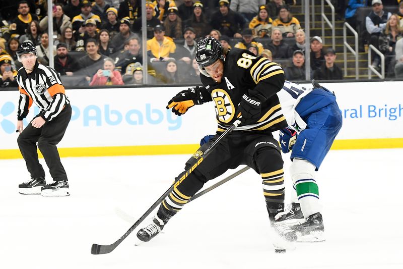 Feb 8, 2024; Boston, Massachusetts, USA; Boston Bruins right wing David Pastrnak (88) tries to control the puck past Vancouver Canucks defenseman Quinn Hughes (43) during the third period at TD Garden. Mandatory Credit: Bob DeChiara-USA TODAY Sports