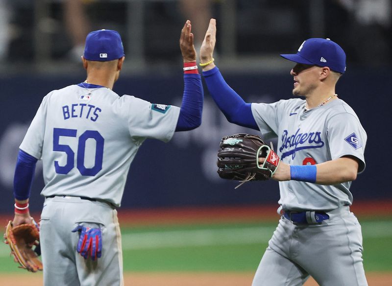 [US, Mexico & Canada customers only] March 20, 2024; Seoul, SOUTH KOREA; Los Angeles Dodgers players Mookie Betts and Enrique Hernandez celebrate after defeating the San Diego Padres during a MLB regular season Seoul Series game at Gocheok Sky Dome. Mandatory Credit: Kim Hong-Ji/Reuters via USA TODAY Sports