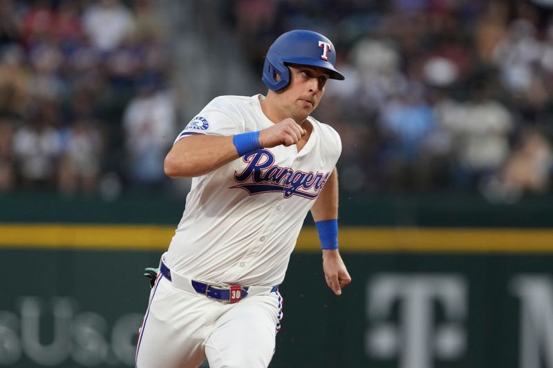 Sep 7, 2024; Arlington, Texas, USA; Texas Rangers first baseman Nathaniel Lowe (30) rounds third base on his way to score on a double hit by Texas Rangers left fielder Ezequiel Duran (not shown) during the fifth inning against the Los Angeles Angels at Globe Life Field. Mandatory Credit: Jim Cowsert-Imagn Images