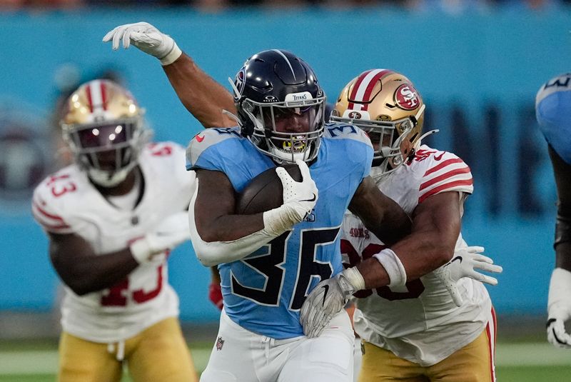 Tennessee Titans running back Julius Chestnut (36) tries to break away from San Francisco 49ers linebacker Curtis Robinson (36) during the first half of an NFL preseason football game, Saturday, Aug. 10, 2024, in Nashville, Tenn. (AP Photo/Mike Stewart)