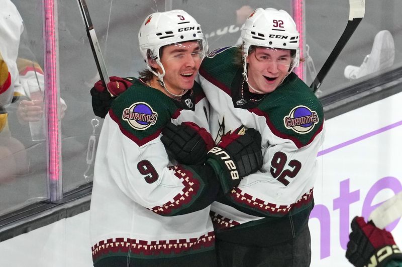 Nov 25, 2023; Las Vegas, Nevada, USA; Arizona Coyotes right wing Clayton Keller (9) celebrates with center Logan Cooley (92) after scoring a goal against the Vegas Golden Knights during the third period at T-Mobile Arena. Mandatory Credit: Stephen R. Sylvanie-USA TODAY Sports