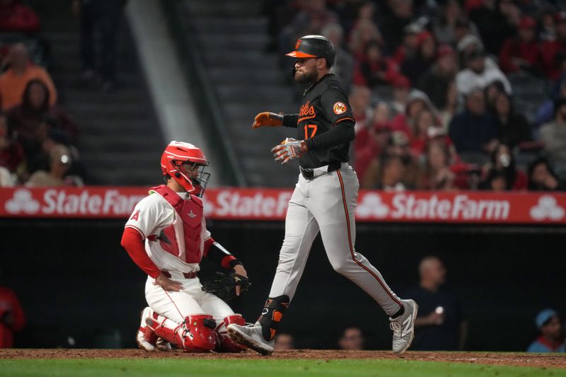 Apr 22, 2024; Anaheim, California, USA; Baltimore Orioles left fielder Colton Cowser (17) crosses home plate after hitting a solo home run in the seventh inning as Los Angeles Angels catcher Logan O'Hoppe (14) watches at Angel Stadium. Mandatory Credit: Kirby Lee-USA TODAY Sports