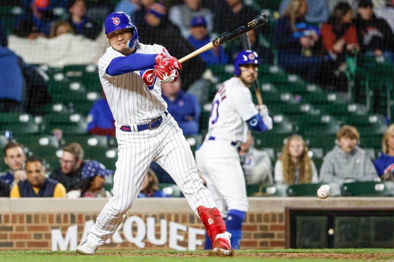 May 25, 2023; Chicago, Illinois, USA; Chicago Cubs right fielder Seiya Suzuki (27) singles against the New York Mets during the eight inning at Wrigley Field. Mandatory Credit: Kamil Krzaczynski-USA TODAY Sports