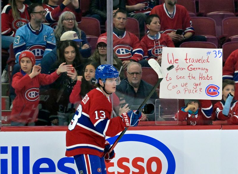 Oct 29, 2024; Montreal, Quebec, CAN; Montreal Canadiens forward Cole Caufield (13) juggles a puck in front of fans during the warmup period before the game against the Seattle Kraken at the Bell Centre. Mandatory Credit: Eric Bolte-Imagn Images