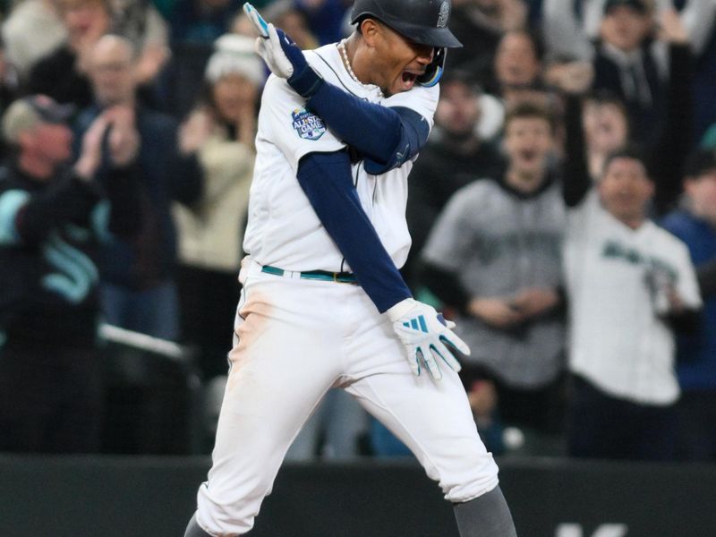 Apr 15, 2023; Seattle, Washington, USA; Seattle Mariners center fielder Julio Rodriguez (44) celebrates at third base after hitting a 3-RBI triple against the Colorado Rockies during the fourth inning at T-Mobile Park. Mandatory Credit: Steven Bisig-USA TODAY Sports