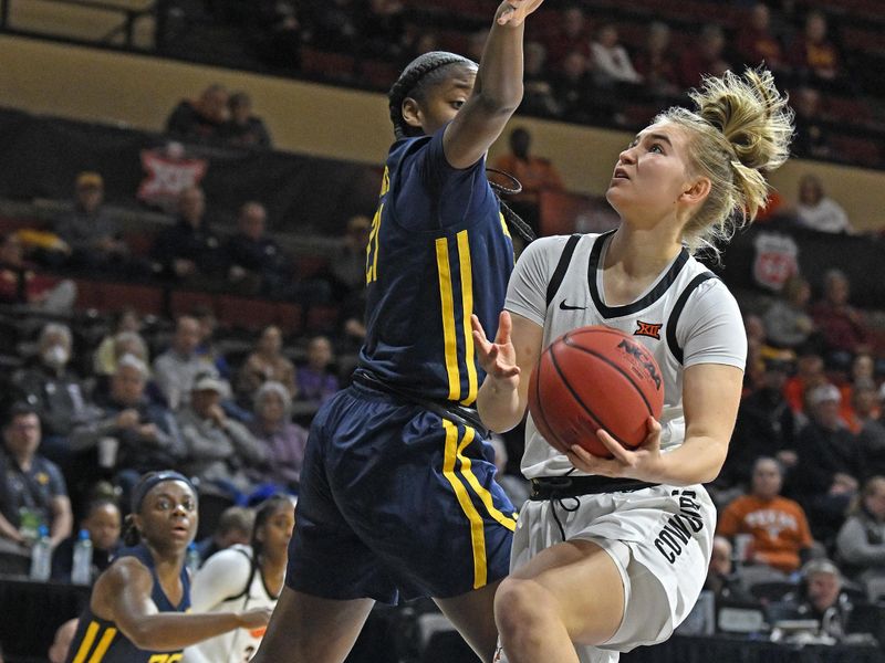 Mar 10, 2023; Kansas City, MO, USA;  Oklahoma State Cowgirls guard Anna Gret Asi (4) drives to the basket against West Virginia Mountaineers forward Tavy Diggs (21)during the first half at Municipal Auditorium. Mandatory Credit: Peter Aiken-USA TODAY Sports