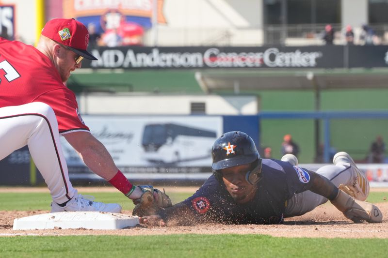 Feb 21, 2026; West Palm Beach, Florida, USA;  Washington Nationals first baseman Sam Brown (85) tags out at Justin Thomas of the Houston Astros in the sixth inning CACTI Park of the Palm Beaches. Mandatory Credit: Jim Rassol-Imagn Images