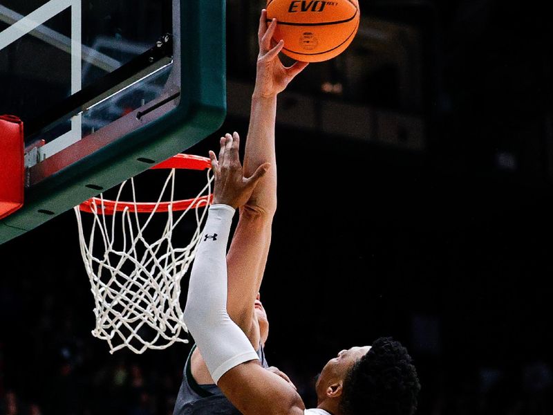 Feb 9, 2024; Fort Collins, Colorado, USA; Colorado State Rams forward Patrick Cartier (12) blocks the shot of San Jose State Spartans guard Myron Amey Jr. (0) in the first half at Moby Arena. Mandatory Credit: Isaiah J. Downing-USA TODAY Sports