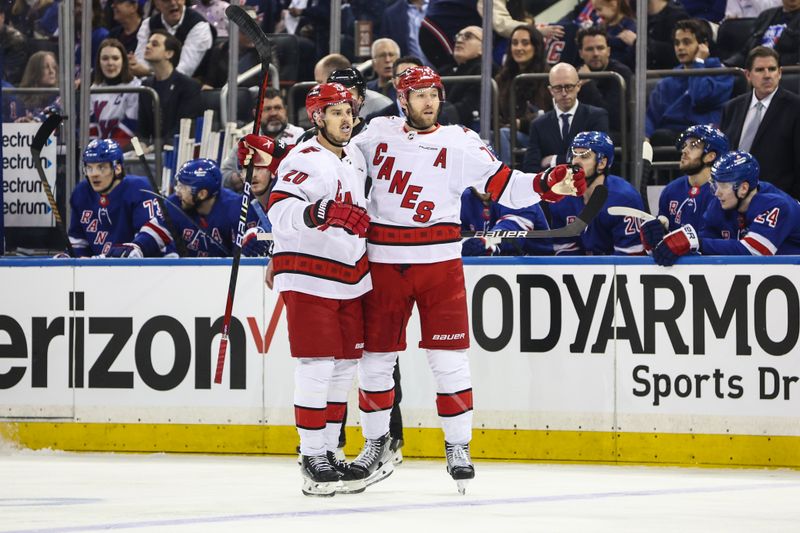 May 5, 2024; New York, New York, USA; Carolina Hurricanes defenseman Jaccob Slavin (74) celebrates with center Sebastian Aho (20) after scoring a goal in the first period against the New York Rangers in game one of the second round of the 2024 Stanley Cup Playoffs at Madison Square Garden. Mandatory Credit: Wendell Cruz-USA TODAY Sports