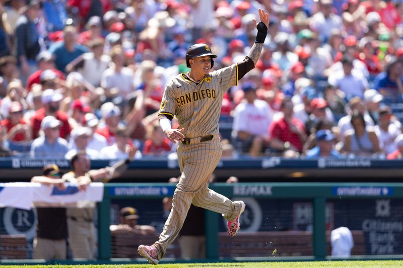 Jun 19, 2024; Philadelphia, Pennsylvania, USA; San Diego Padres third base Manny Machado (13) reacts as he runs home to score against the Philadelphia Phillies during the eighth inning at Citizens Bank Park. Mandatory Credit: Bill Streicher-USA TODAY Sports