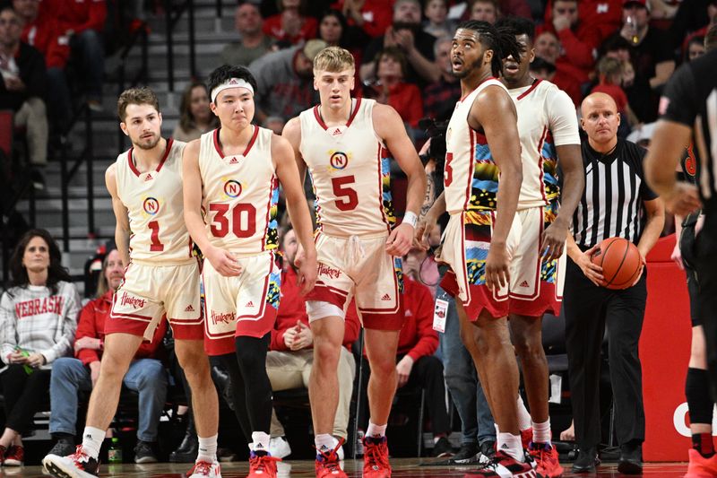 Feb 11, 2023; Lincoln, Nebraska, USA;  Nebraska Cornhuskers guard Sam Hoiberg (1) and guard Keisei Tominaga (30) and guard Sam Griesel (5) and forward Derrick Walker (13) and forward Blaise Keita (15) gather after a foul call against the Wisconsin Badgers in the second half at Pinnacle Bank Arena. Mandatory Credit: Steven Branscombe-USA TODAY Sports